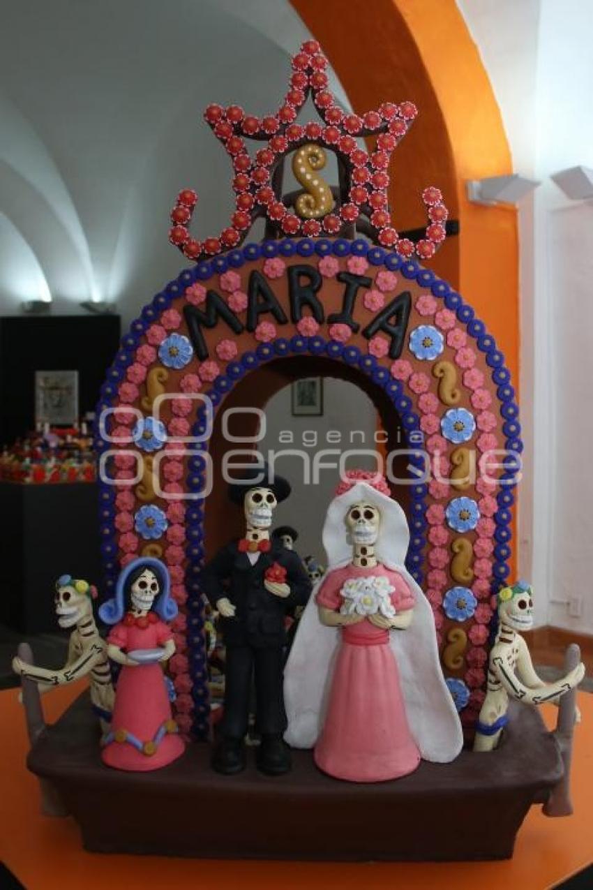 EXPOSICIÓN . DE MUERTOS Y JOLGORIOS